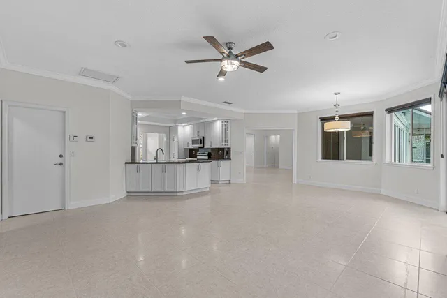 a view of empty room with a kitchen