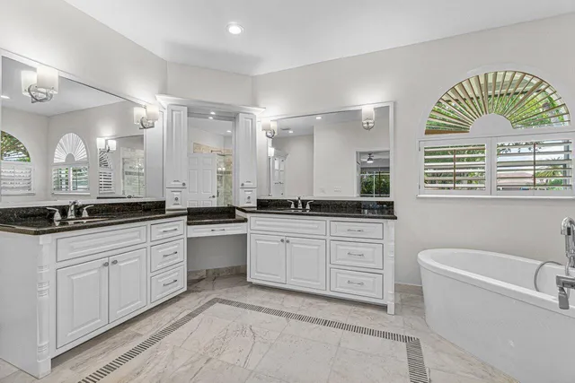 a large bathroom with a large tub sink and vanity