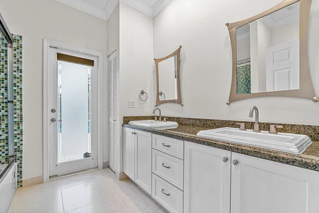 a bathroom with double sink and a mirror