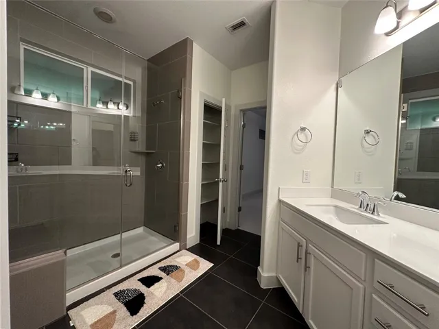 a bathroom with a double vanity sink toilet and a mirror