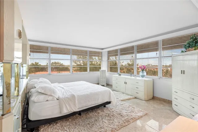 a living room with furniture and flowers