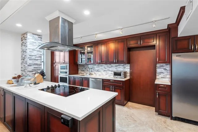 a bathroom with a granite countertop sink a large mirror and a bathtub