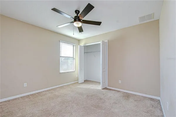 an empty room with windows and mirror