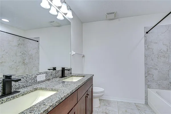a view of bathroom with a toilet sink and mirror
