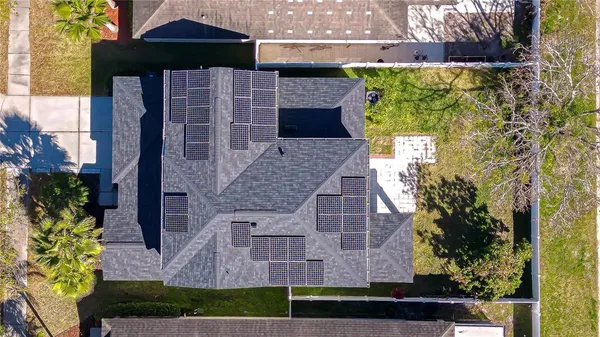 an aerial view of a house with a yard