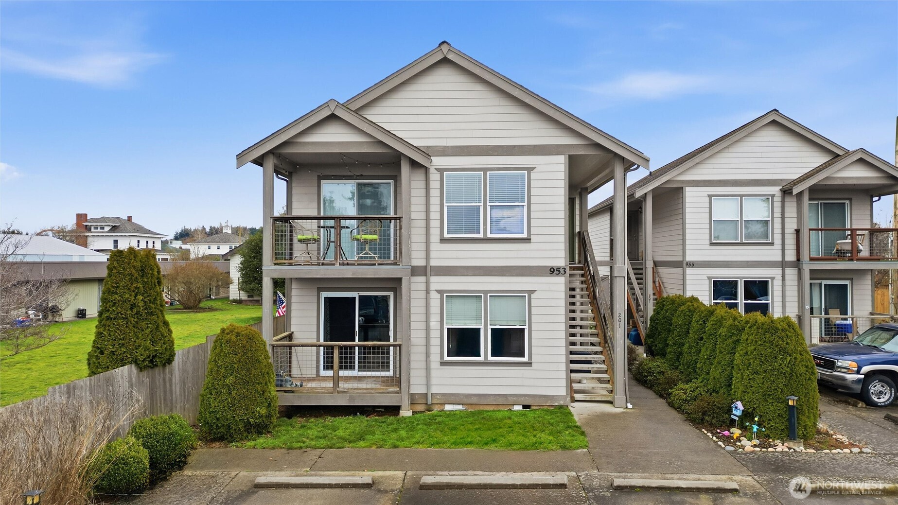 953 3rd Street, Unit 101 Blaine, WA 98230 - Photo 1 of 28 a view of a brick house with many windows next to a yard