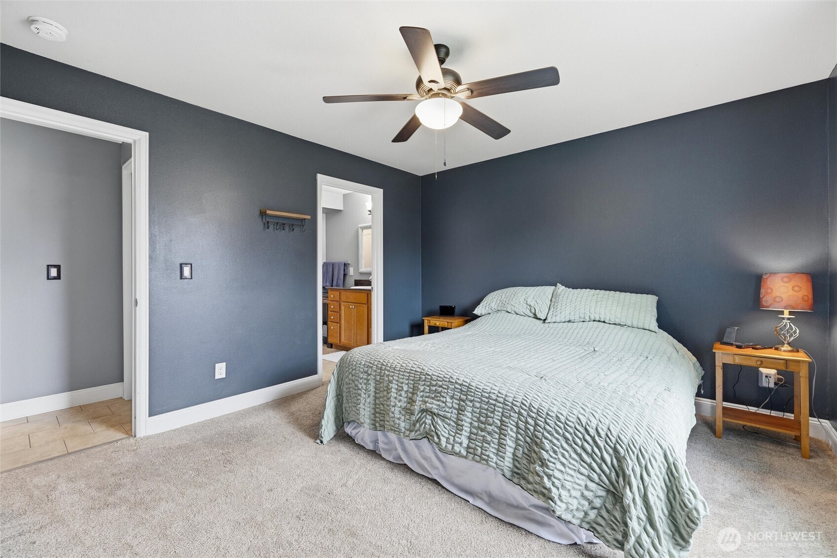 953 3rd Street, Unit 101 Blaine, WA 98230 - Photo 14 of 28 a bedroom with a bed and a ceiling fan