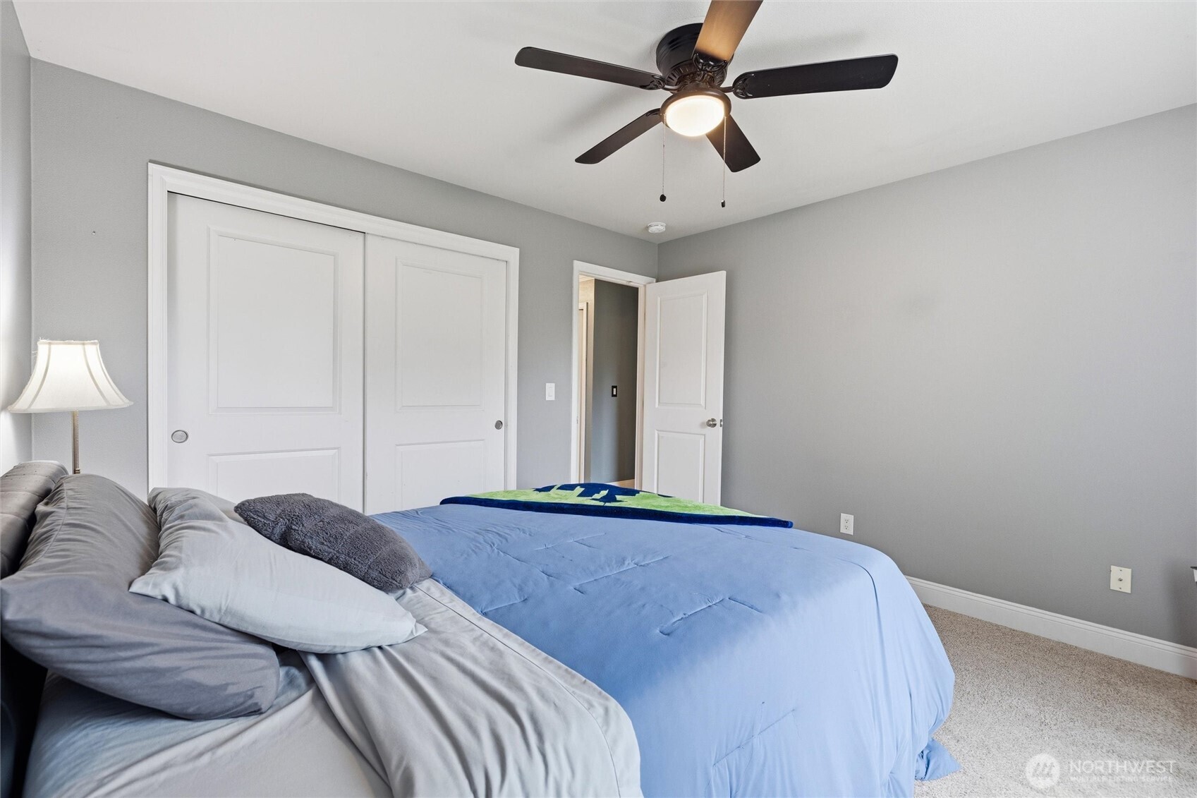 953 3rd Street, Unit 101 Blaine, WA 98230 - Photo 18 of 28 a bedroom with a large bed and a chandelier