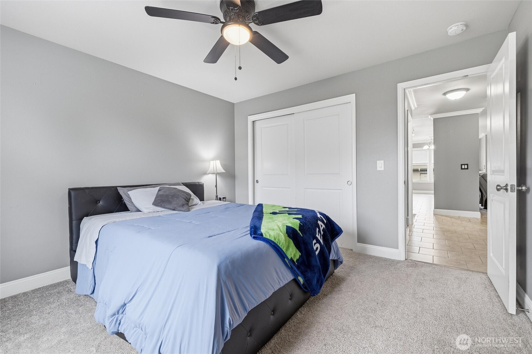 953 3rd Street, Unit 101 Blaine, WA 98230 - Photo 20 of 28 a bedroom with a bed and a chandelier