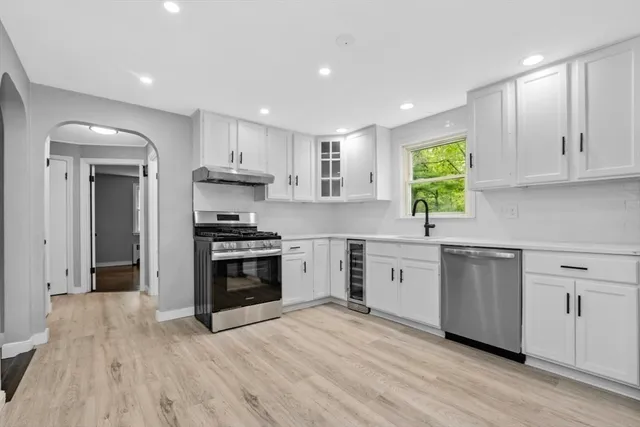 a kitchen with stainless steel appliances granite countertop a refrigerator sink and stove