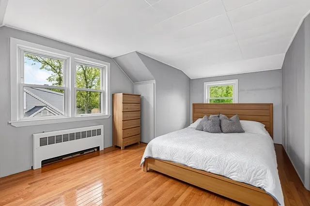an empty room with a window and wooden floor