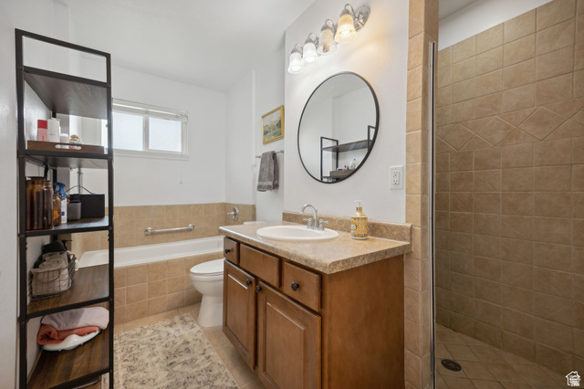 495 North 250 West Springville, UT 84663 - Photo 15 of 35 Bathroom with vanity, a shower stall, a garden tub, and light tile patterned floors