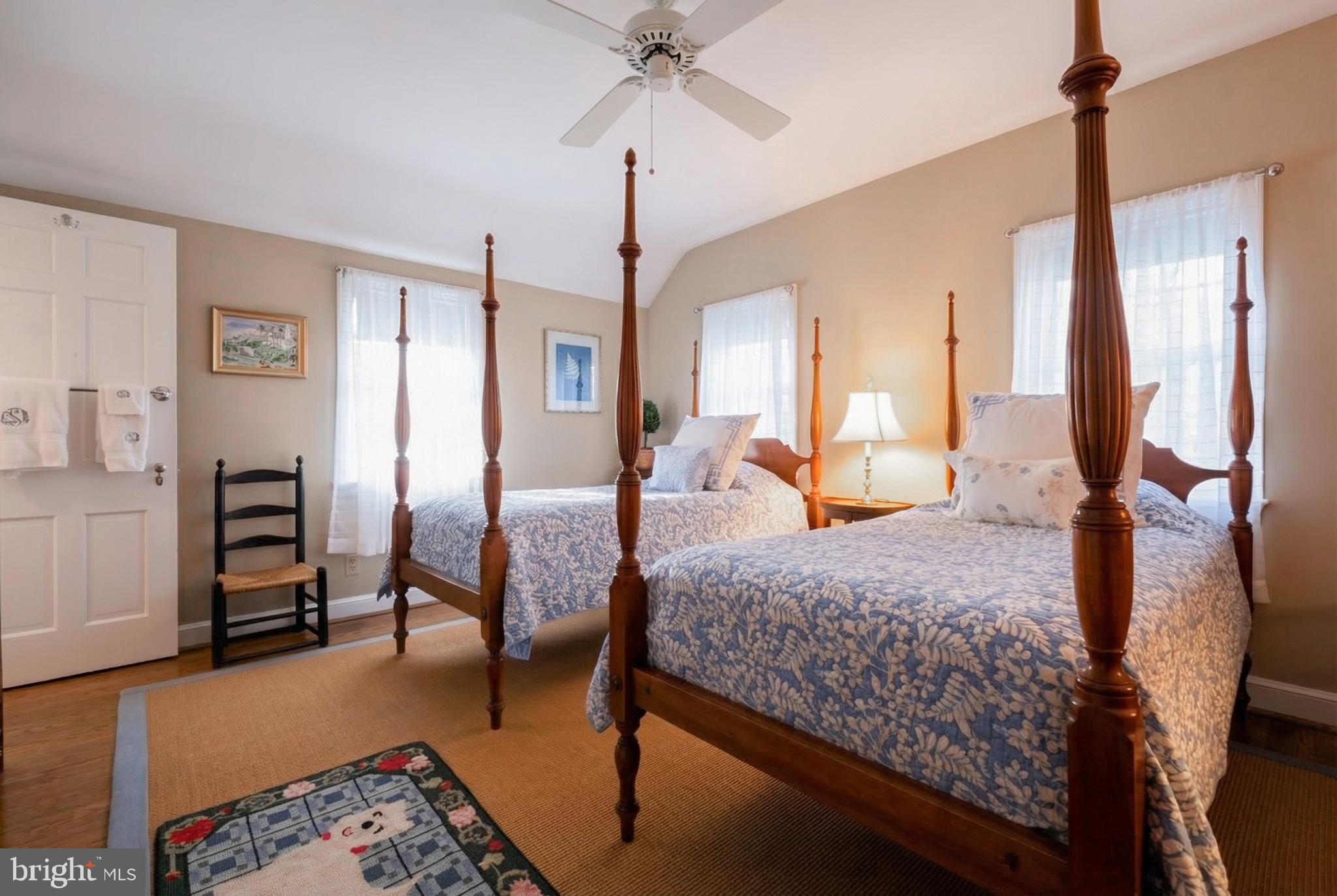 810 Merion Square Road Gladwyne, PA 19035 - Photo 17 of 32 a bedroom with a bed lamps and chairs