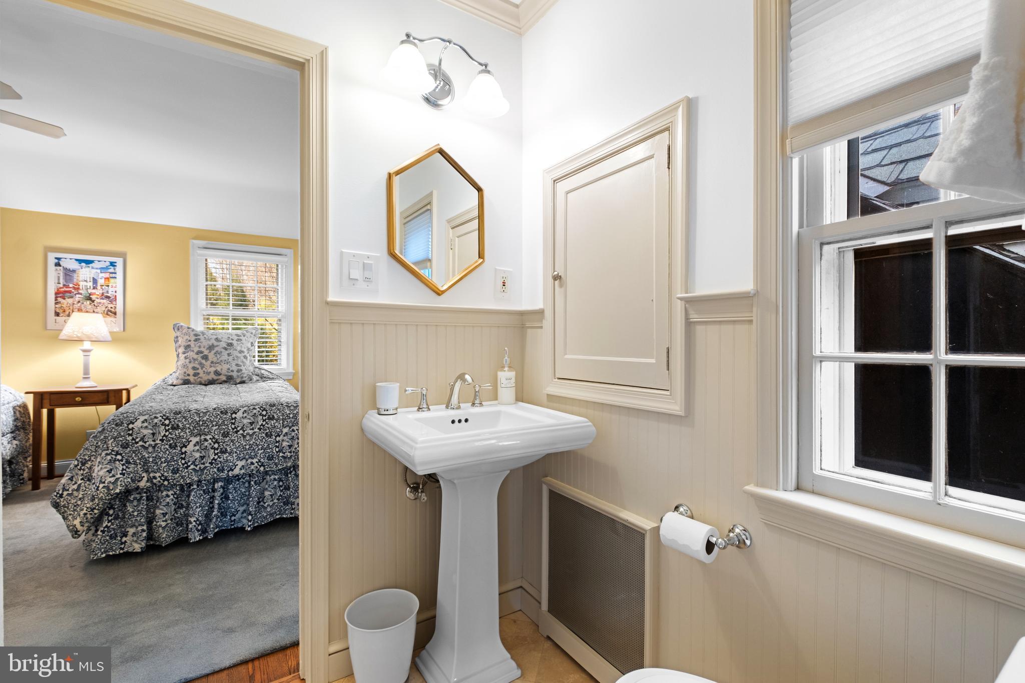 810 Merion Square Road Gladwyne, PA 19035 - Photo 20 of 32 a bathroom with a sink a mirror and a window