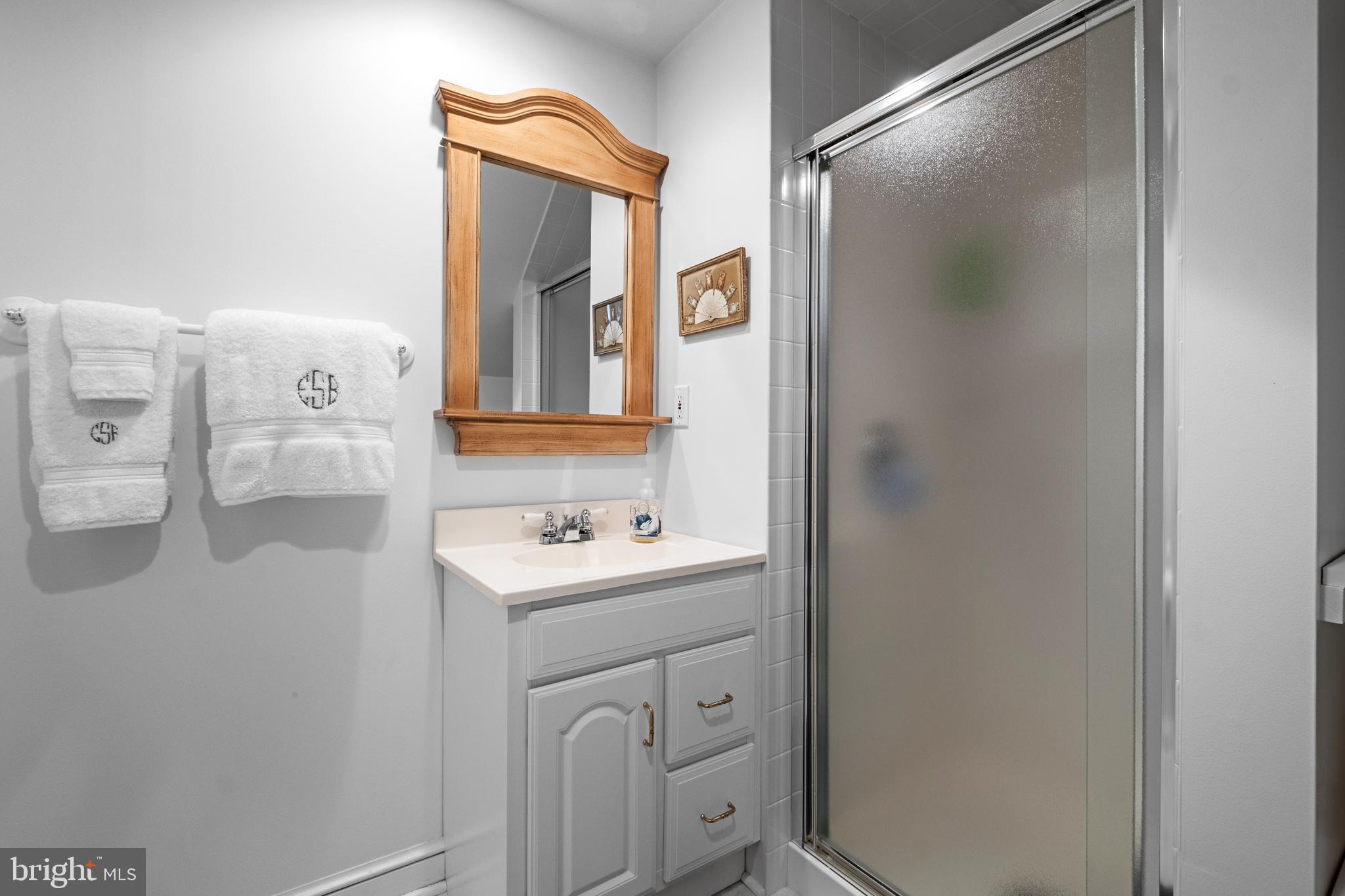810 Merion Square Road Gladwyne, PA 19035 - Photo 23 of 32 a bathroom with a sink a toilet and mirror