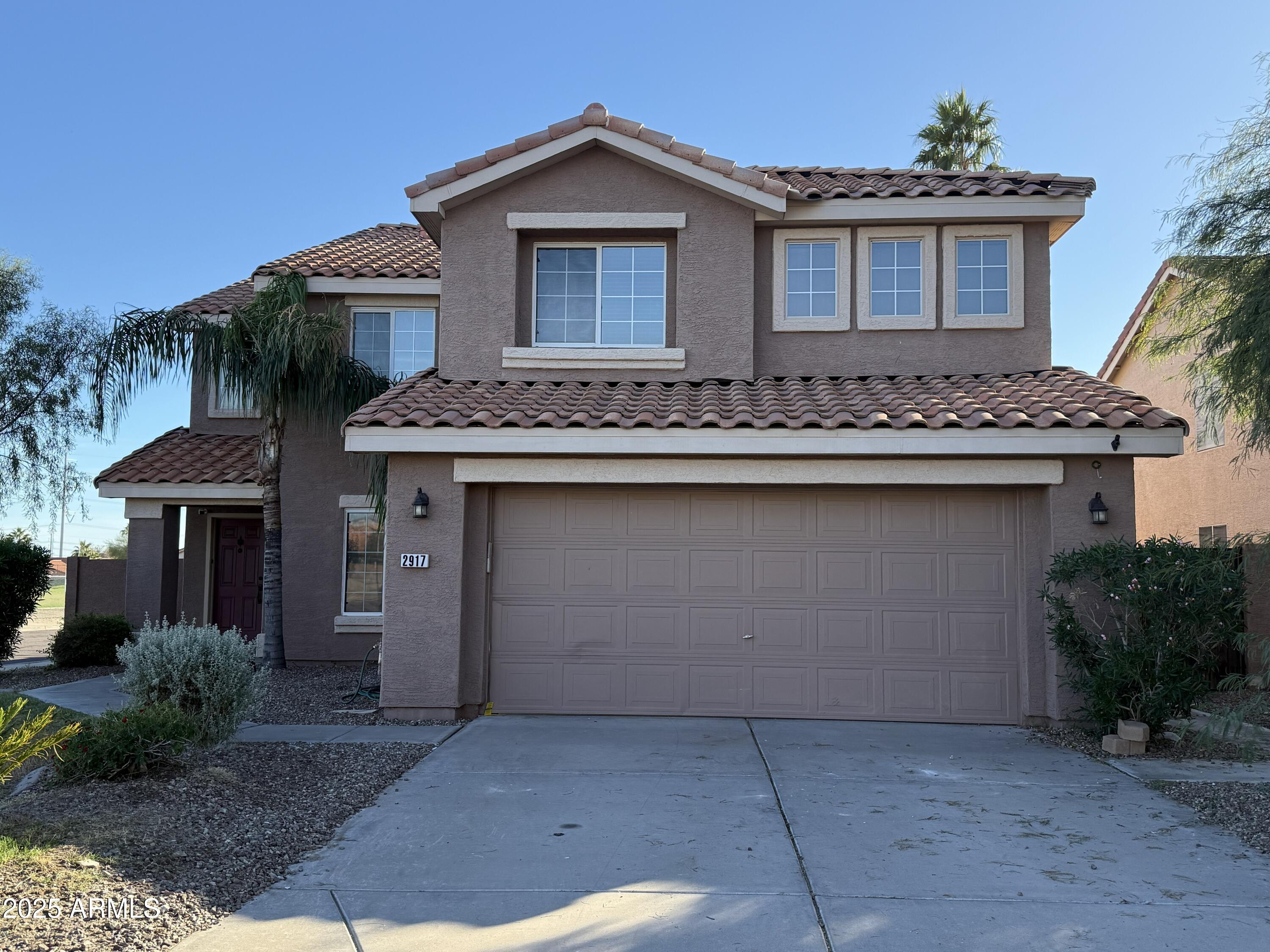2917 East Windsong Drive Phoenix, AZ 85048 - Photo 1 of 26 a front view of a house with yard