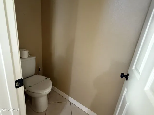 a white toilet sitting next to a small window