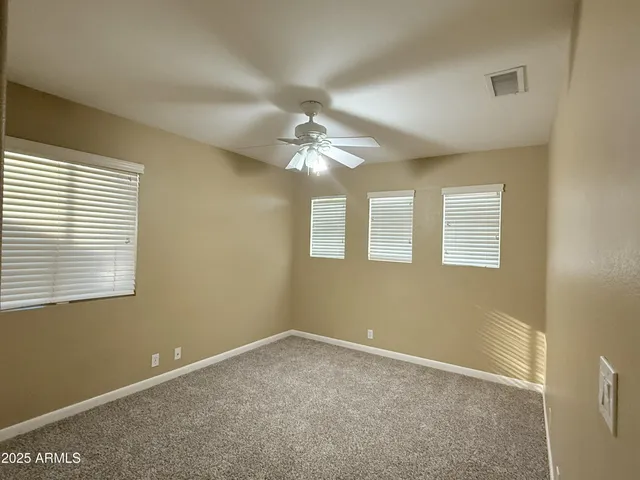 a view of a livingroom with a ceiling fan and window