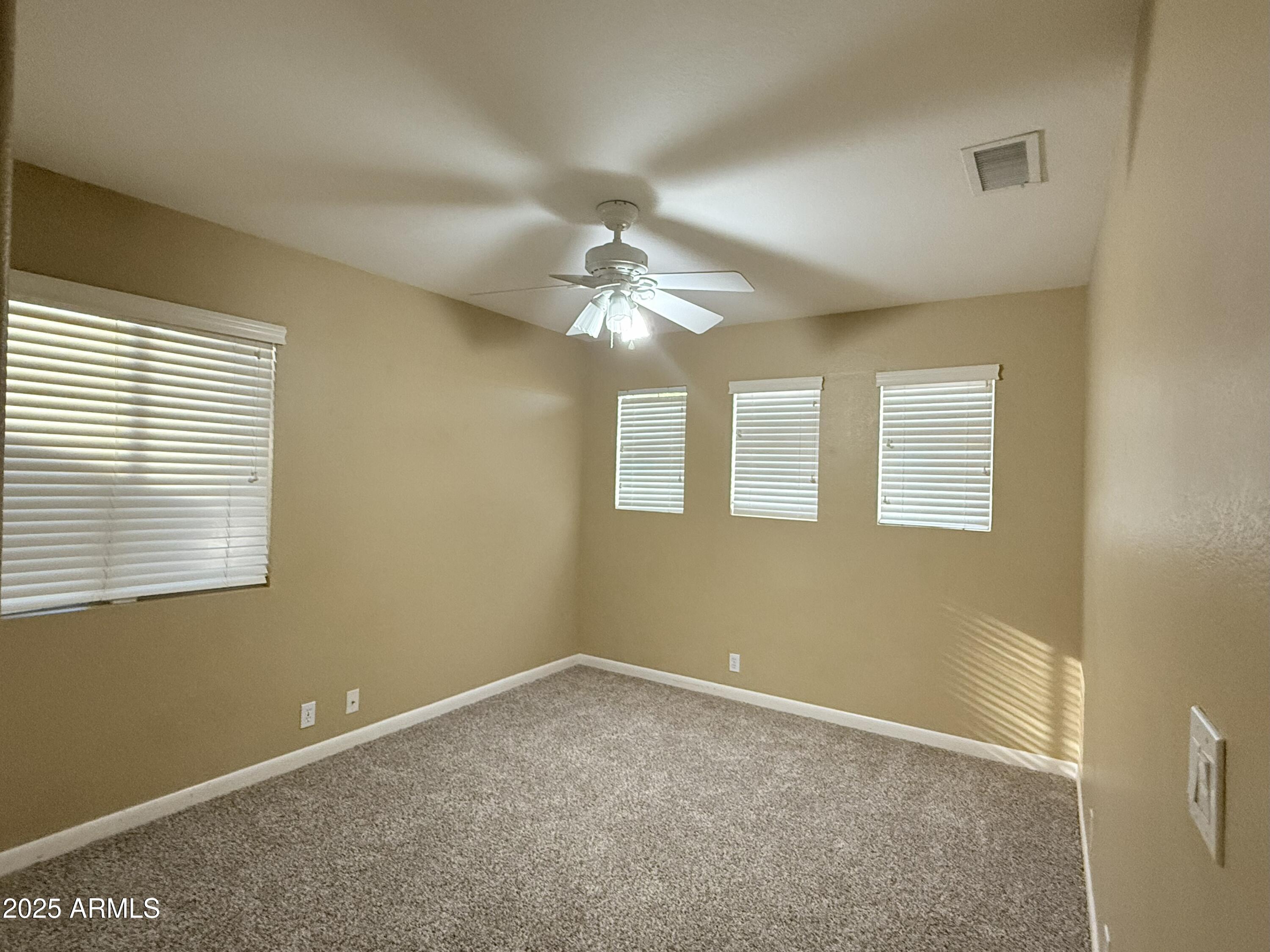 2917 East Windsong Drive Phoenix, AZ 85048 - Photo 17 of 26 a view of a livingroom with a ceiling fan and window