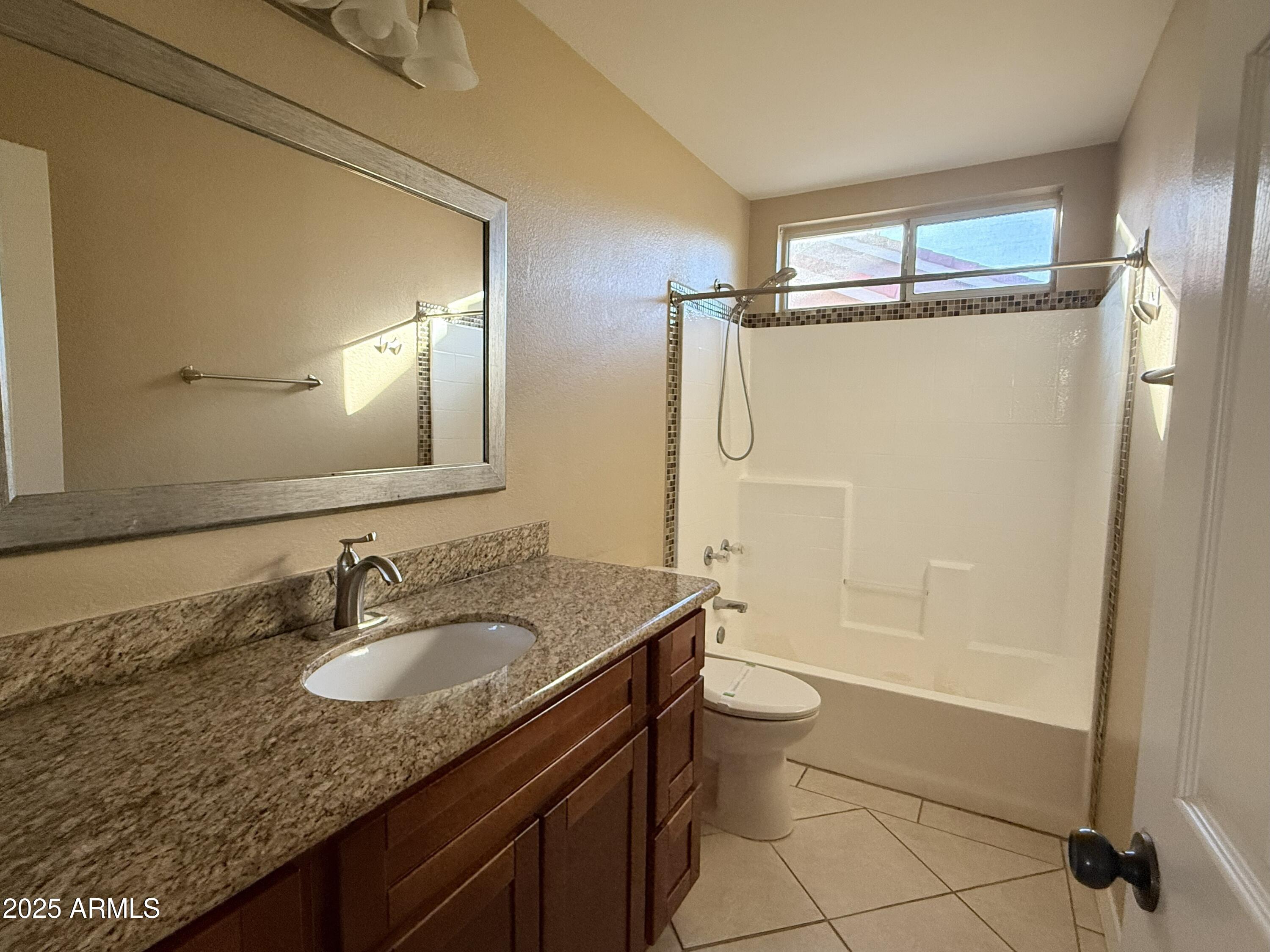 2917 East Windsong Drive Phoenix, AZ 85048 - Photo 18 of 26 a bathroom with a granite countertop sink toilet mirror and shower