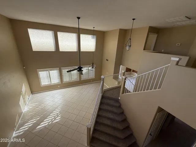 a hallway with stairs and wooden floor