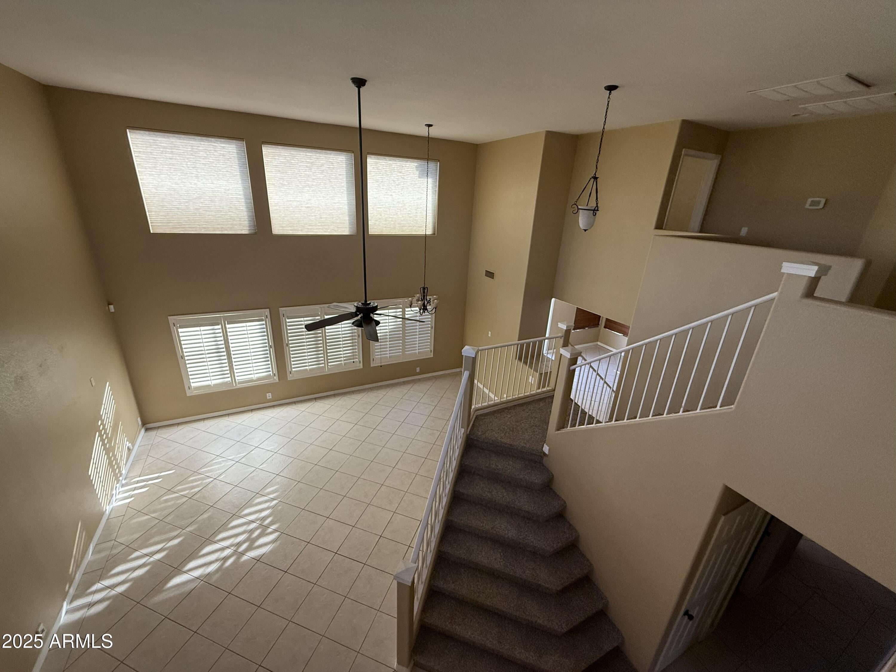 2917 East Windsong Drive Phoenix, AZ 85048 - Photo 4 of 26 a hallway with stairs and wooden floor