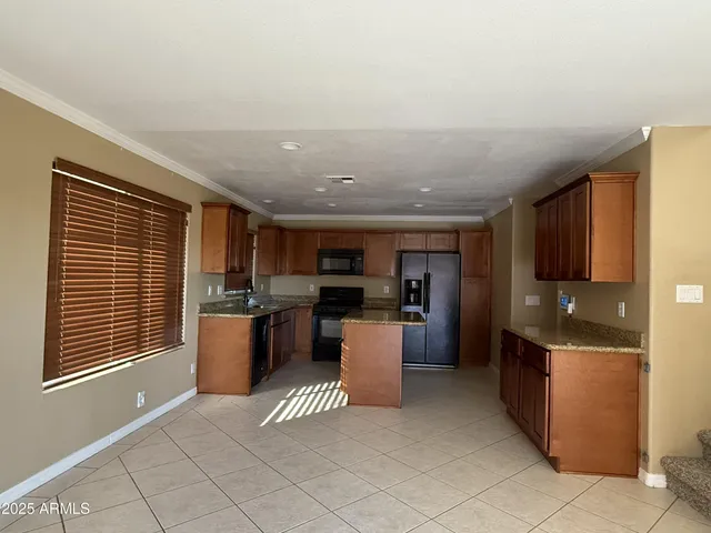 a kitchen with refrigerator and cabinets