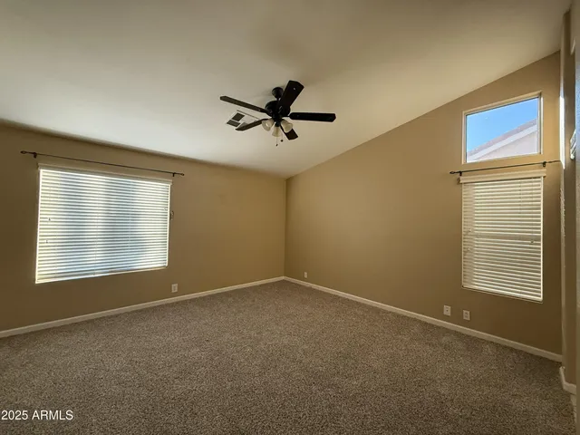a view of a livingroom with a ceiling fan and window