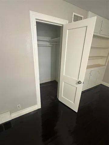 an entryway door with wooden floor