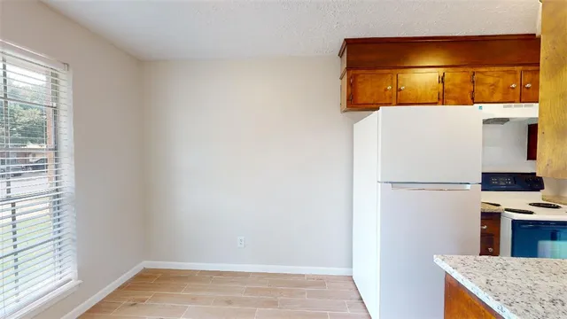 a view of kitchen with a refrigerator