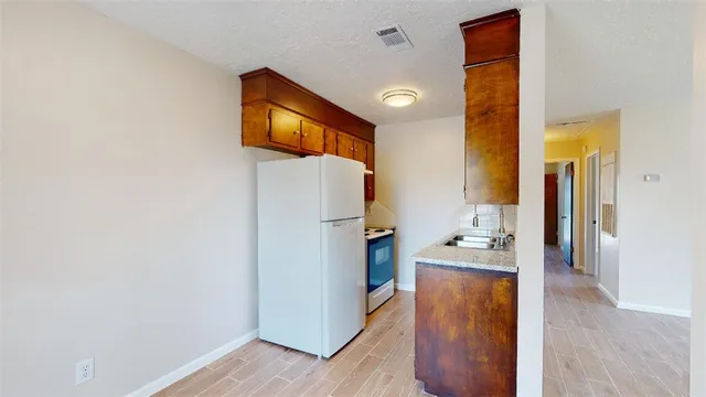 a en suite bathroom with a toilet sink and mirror