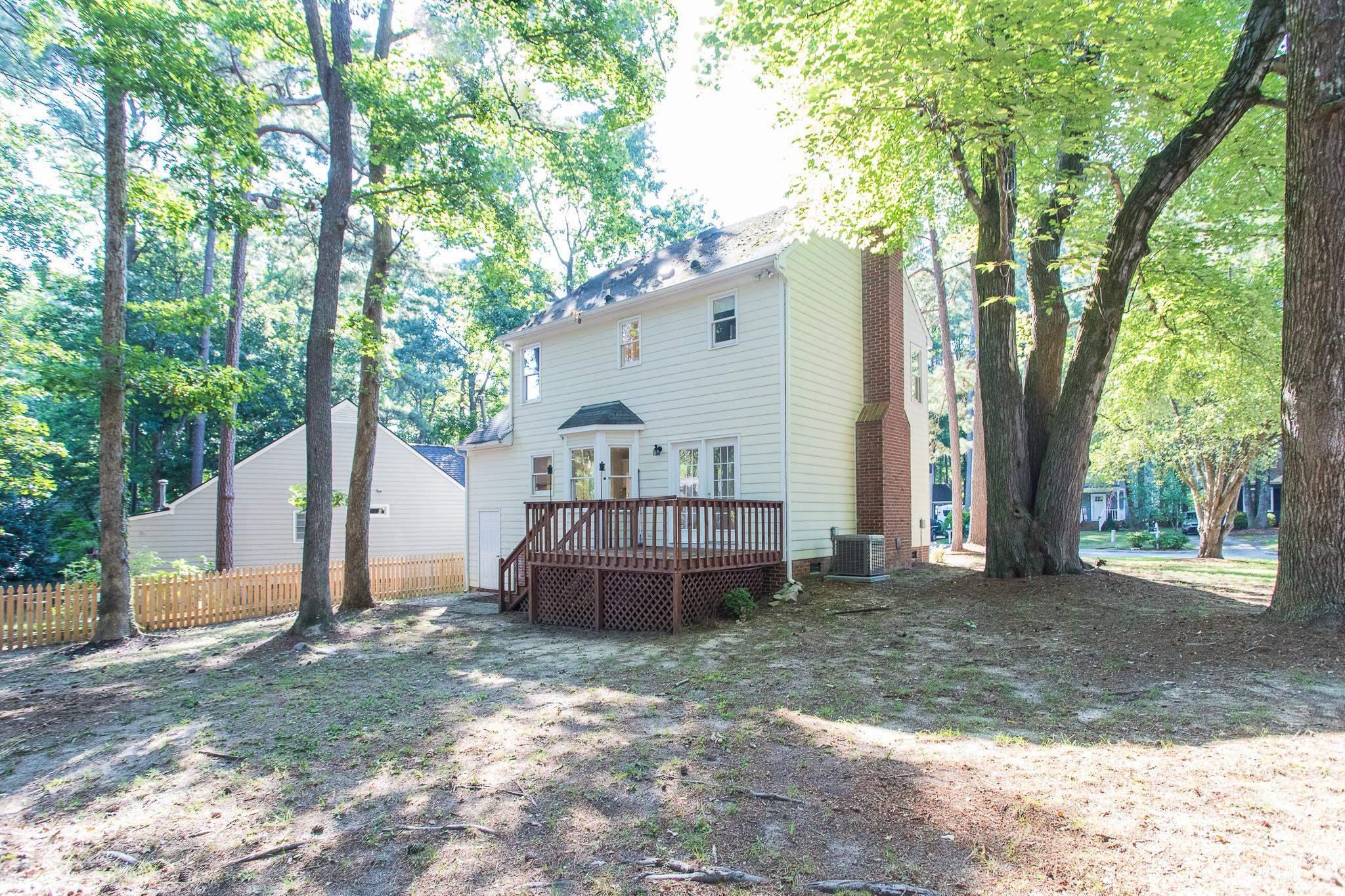 4701 Thurmount Place Raleigh, NC 27604 - Photo 5 of 32 a view of a house with a yard and large tree