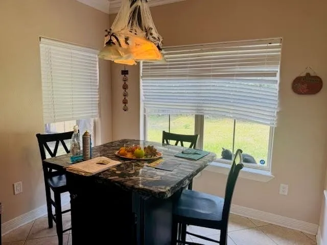 a view of a dining room with furniture and window