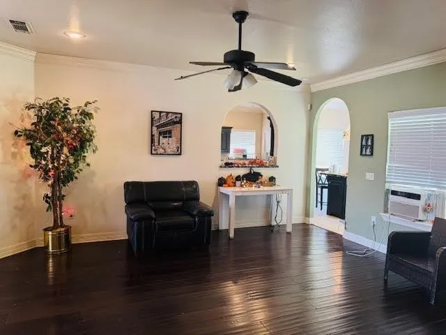 a living room with furniture or wooden floor and a chandelier