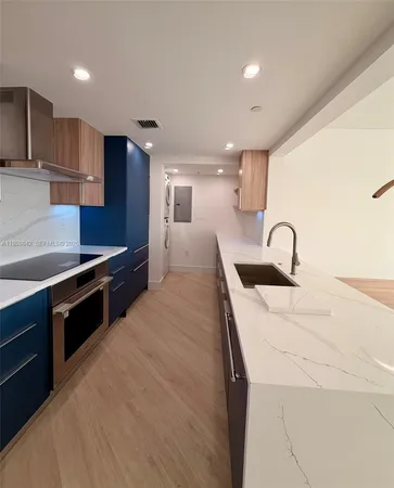 a kitchen with stainless steel appliances sink a stove and a refrigerator