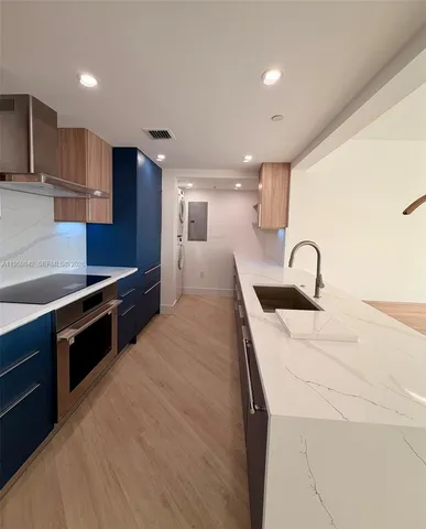 a kitchen with stainless steel appliances sink a stove and a refrigerator