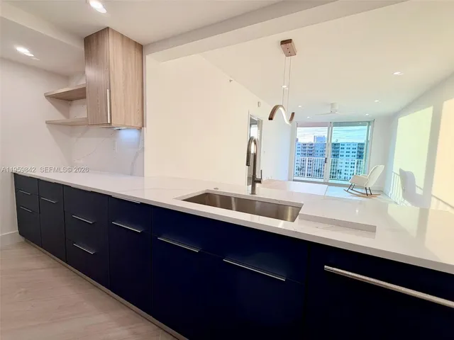 a kitchen with a sink and a window