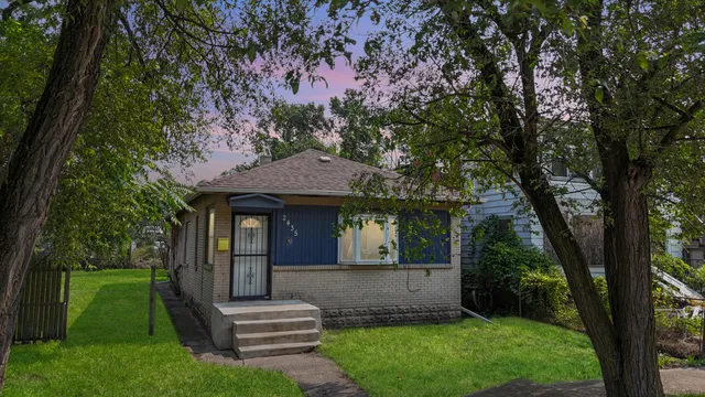 a front view of a house with a garden