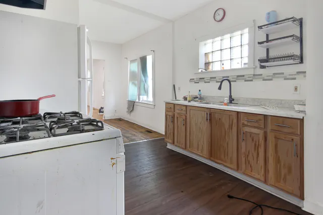 a kitchen with stainless steel appliances a sink stove and cabinets