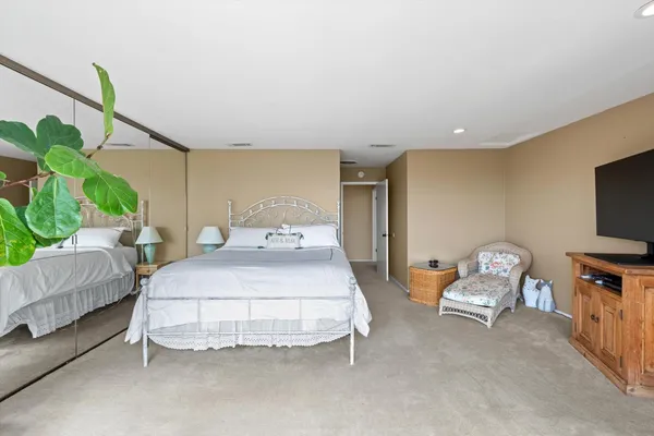 a bedroom with a bed and a chair