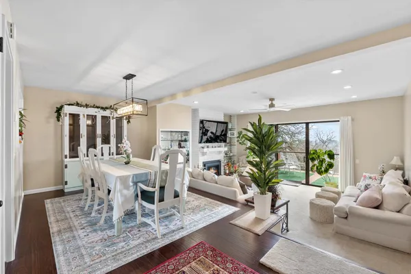 a living room with furniture large window and wooden floor