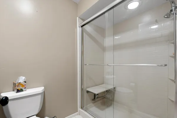 a bathroom with a toilet and a shower