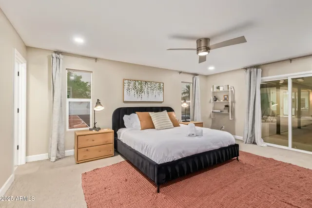 a kitchen with stainless steel appliances kitchen island granite countertop a table chairs and white cabinets
