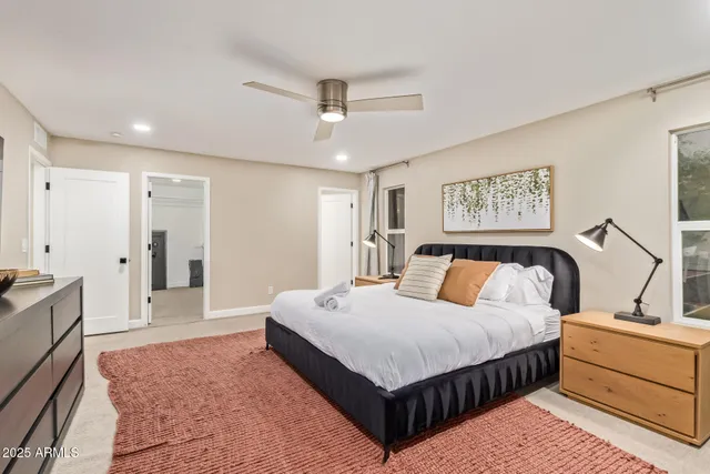 a bedroom with a large bed and a window