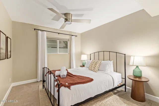 a bedroom with a bed and a lamp