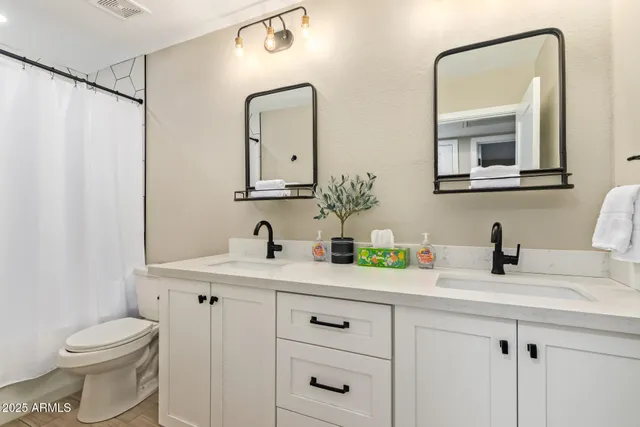 a bedroom with a bed and potted plant