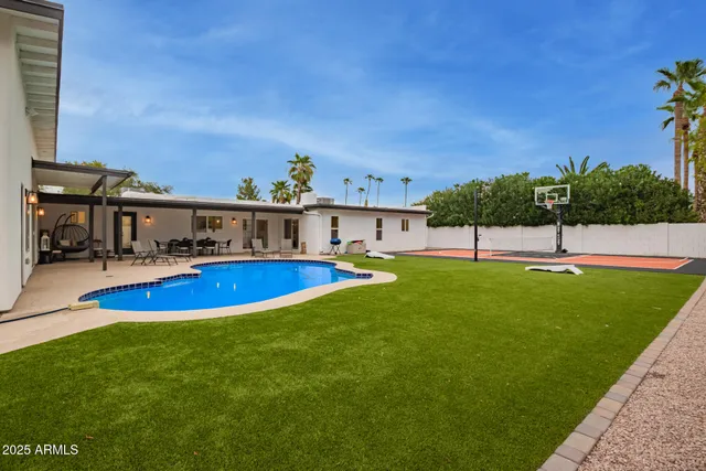a backyard of a house with table and chairs