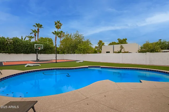 a view of a swimming pool with lawn chairs
