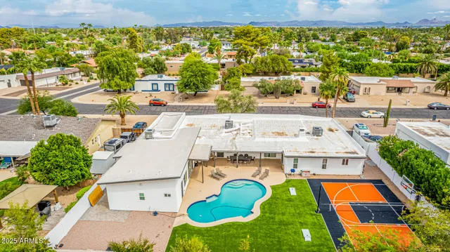 an aerial view of residential houses with outdoor space and swimming pool