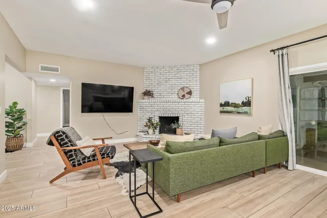 a living room with furniture and a fireplace